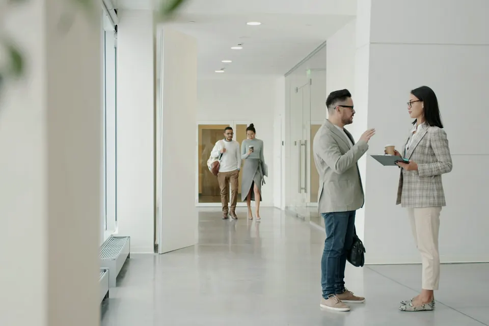 Dos agentes inmobiliarios conversando en una vivienda